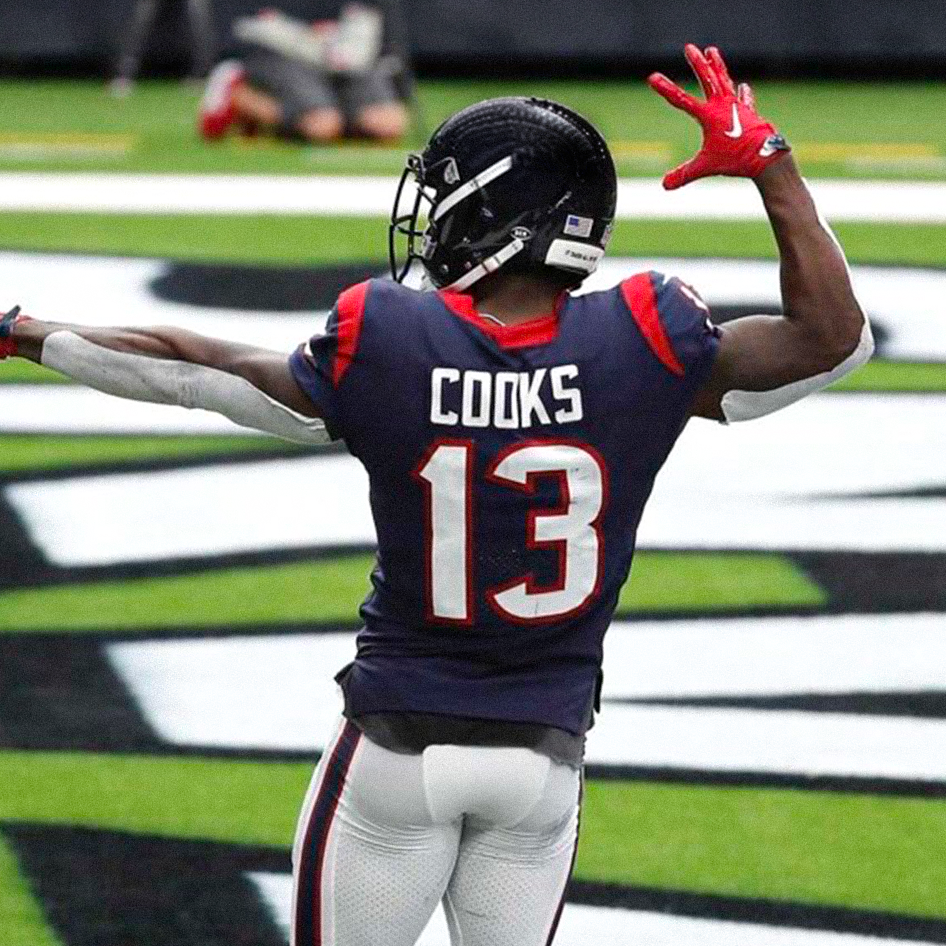 Brandin Cooks raising both arms in the end zone, back view showing jersey COOKS 13 on a football field