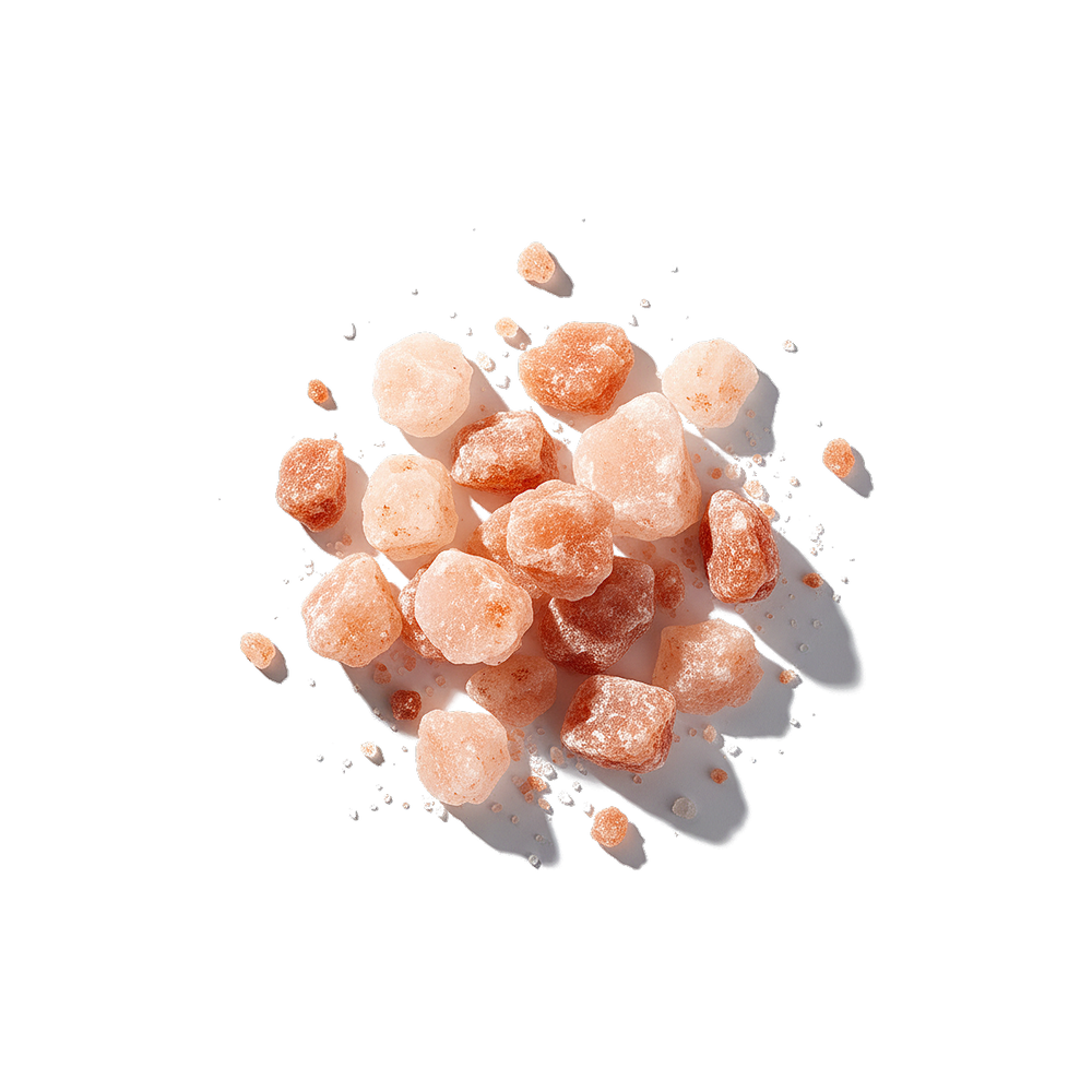 Top-down view of Pink Himalayan salt crystals showcasing coarse pink-orange chunks with scattered grains on a white backdrop